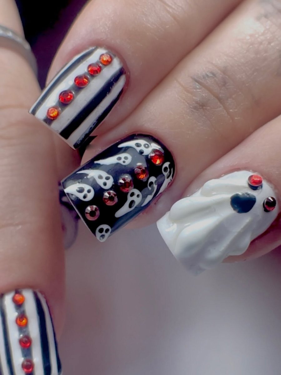 Halloween nail art: a 3D white ghost, white ghosts on black, and black and white stripes with red gems