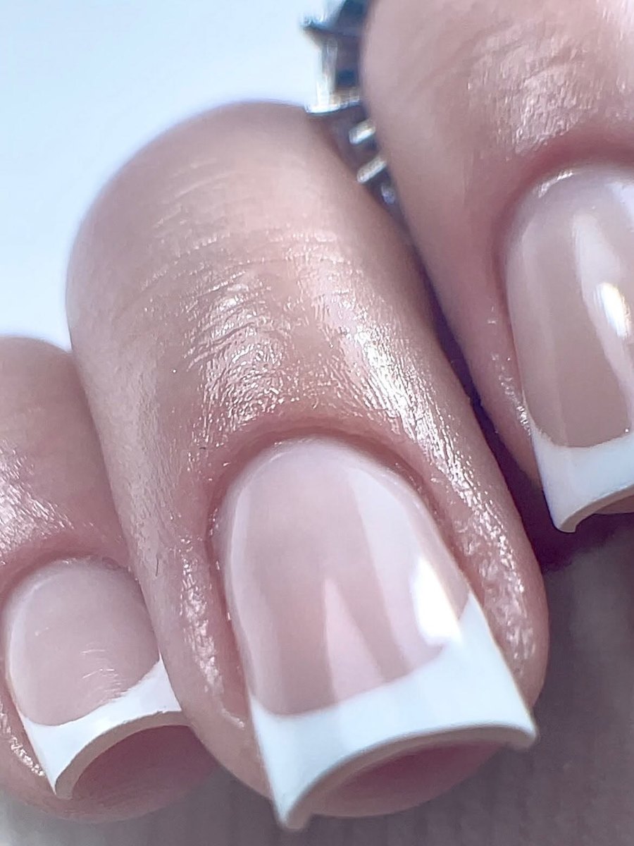 Close-up of a classic white French tip on a square nail